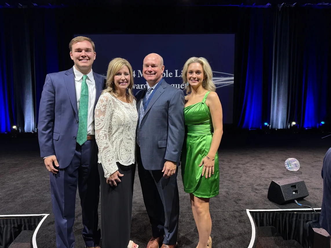 Richard Johnson with colleagues on stage at an industry event